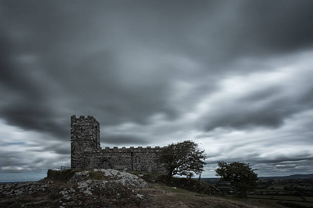 Brentor church with rushing clouds on a grey afternoon