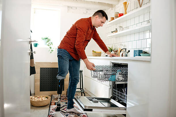 istock Dishwasher being used by a man in the kitchen 2218752921