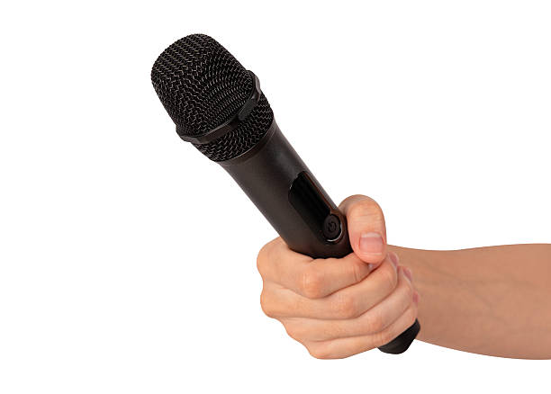 istock Hand holding wireless microphone isolated on white background. Premium high quality studio shot. Concept for entertainment and recreation. 2218753358
