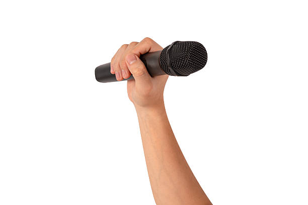 istock Hand holding wireless microphone isolated on white background. Premium high quality studio shot. Concept for entertainment and recreation. 2218753884