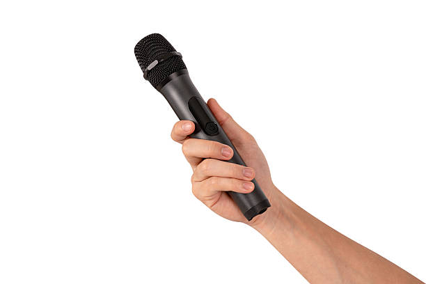 istock Hand holding wireless microphone isolated on white background. Premium high quality studio shot. Concept for entertainment and recreation. 2218753888