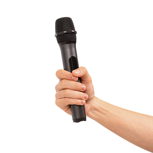 istock Hand holding wireless microphone isolated on white background. Premium high quality studio shot. Concept for entertainment and recreation. 2218753915