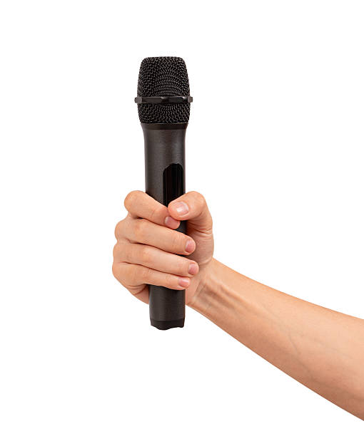 istock Hand holding wireless microphone isolated on white background. Premium high quality studio shot. Concept for entertainment and recreation. 2218753920