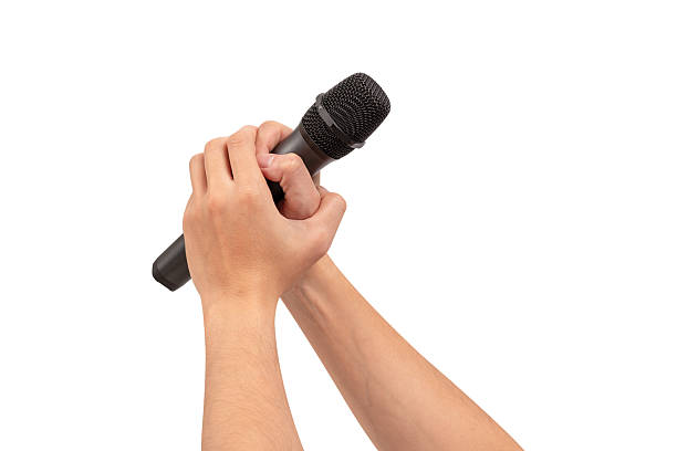 istock Hand holding wireless microphone isolated on white background. Premium high quality studio shot. Concept for entertainment and recreation. 2218753934
