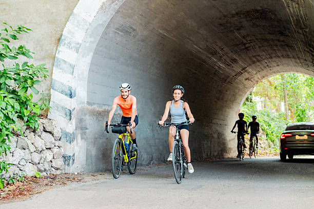 Man and woman on racing bicycles passing at Pistenende at Swiss village of Oberglatt on a sunny summer day. Photo taken July 12th, 2025, Zurich Oberglatt, Switzerland.