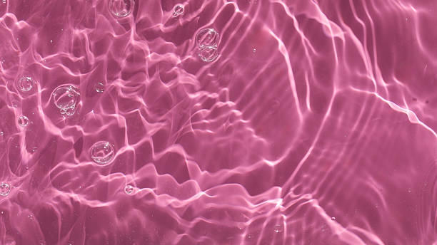 istock Abstract background of pink water with ripples under sunlight. Top view, copy space 2218755162
