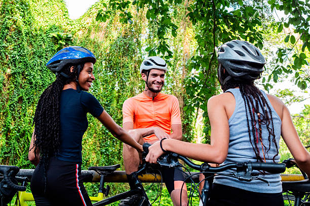 istock Young cyclists friends talking on public park 2218755562