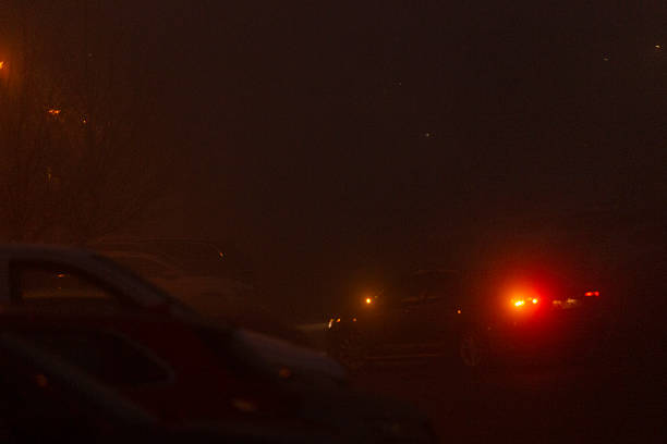 istock Vehicles Moving Through Heavy Fog with Extremely Low Visibility Levels 2218757206