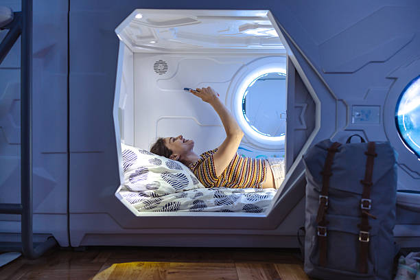 istock Relaxing in a modern capsule hotel pod with blue ambient lighting 2218757579