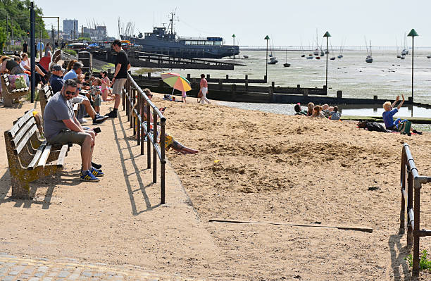Leigh on Sea, Essex, United Kingdom, May 31, 2025. Bell Sands Wharf beach. 'Hidden' or 'secret stretch of sand at end of Leigh Old Town main street. Incidental people sunbathing. Sunny spring summer day outdoors.