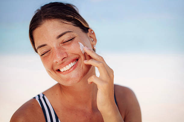 istock Woman Applying Sunscreen on Sunny Beach 2218762252
