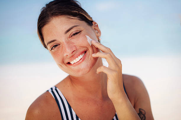 istock Woman Applying Sun Cream on Beach 2218762303