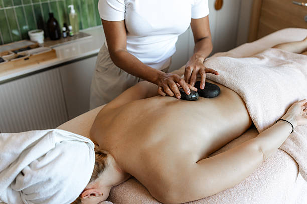 istock Professional spa treatment session with hot stone massage in a relaxing setting 2218765389