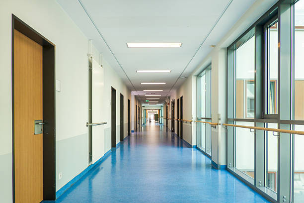 Modern hospital corridor with blue flooring and window front