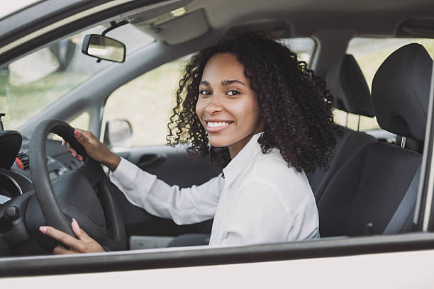 istock Young woman driving a car 2218770599