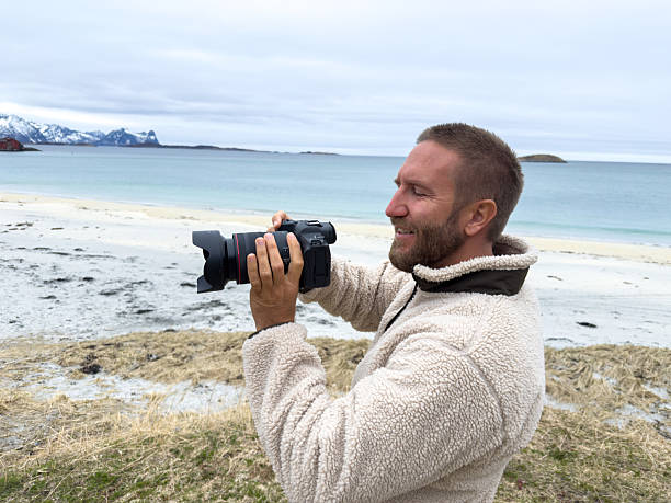 istock Photographer Capturing Scenic Beach Landscape 2218771637