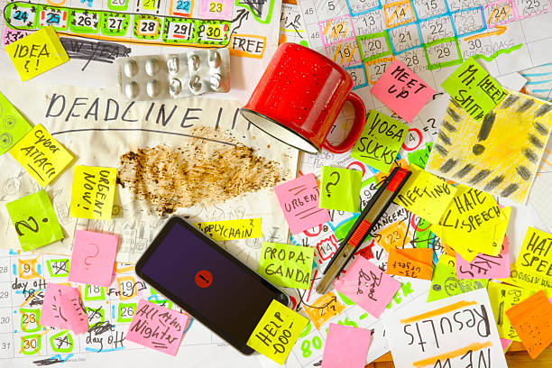 istock Calendars with business appointments, deadline notice and adhesive notes on cluttered desk. Business concept,beat the clock,stress,overwoked,bureaucracy 2218771759