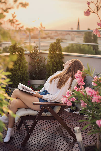 istock Dreaming Woman with Book on Knees 2218771809