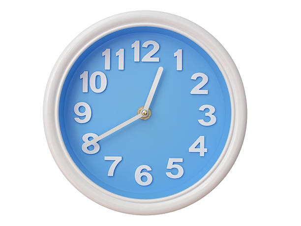 VSimple round wall clock with black frame and white face, showing the time exactly at 00:40 or 12:40. Representing time precision in concepts of deadlines.