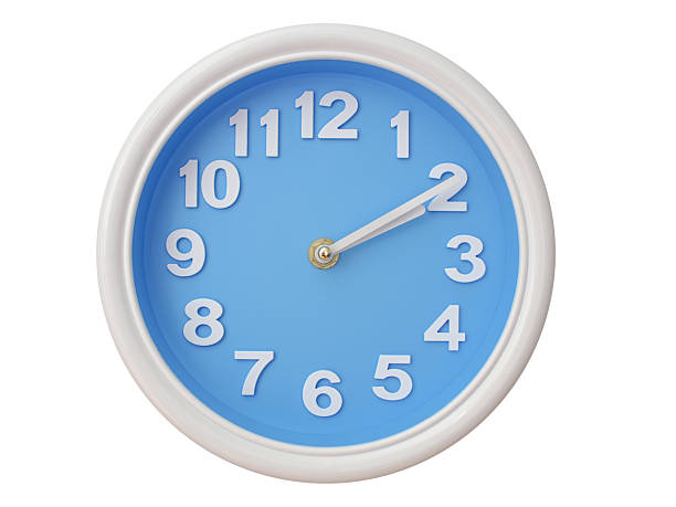 Wall clock with a blue face and white frame showing exactly 02:10 or 14:10. Represents time, deadlines.