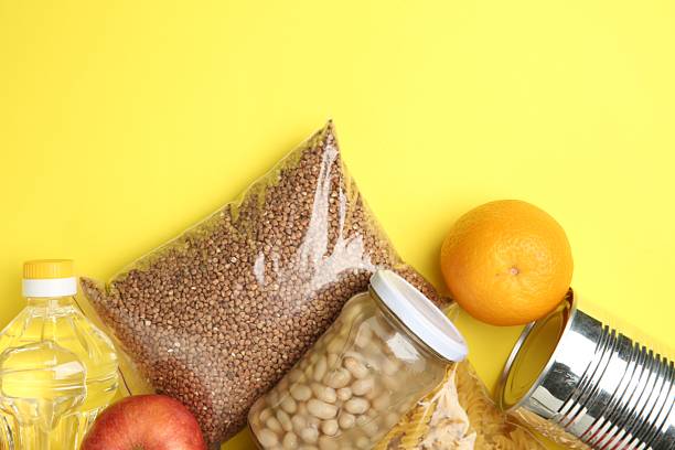 istock Food donation. Different products on yellow background, flat lay. Space for text 2218777671