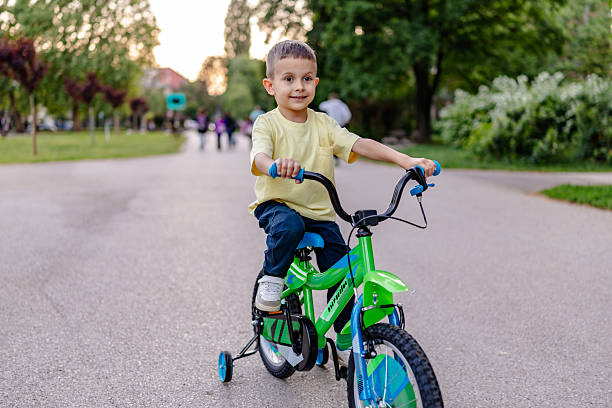Small boy riding a bike with beautiful sunshine
