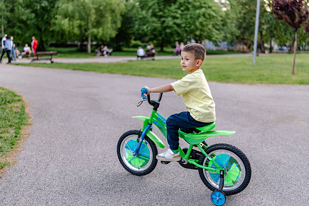 istock Boy enjoys cycling in a natural park on a sunny spring day 2218779259