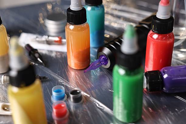 istock Tattoo machine and colorful inks on table, closeup 2218779837