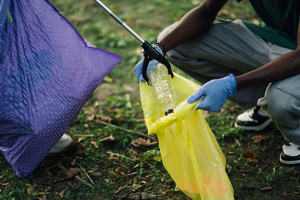 istock Volunteers collecting plastic bottle in a public park using trash picker 2218780221