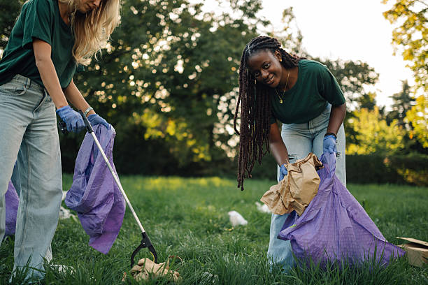istock Volunteers picking up trash in a public park 2218780327
