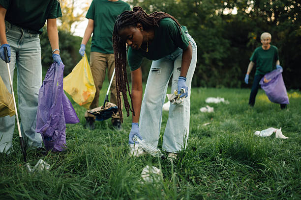 istock Volunteers picking up trash in a public park 2218780360