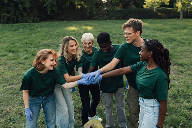 istock Volunteers putting hands together after cleaning park 2218780379