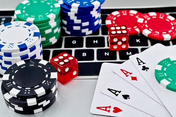 istock Gambling chips and playing card on laptop keyboard 2218780856