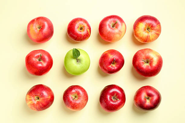 istock Red apples and green one on beige background, flat lay 2218781055