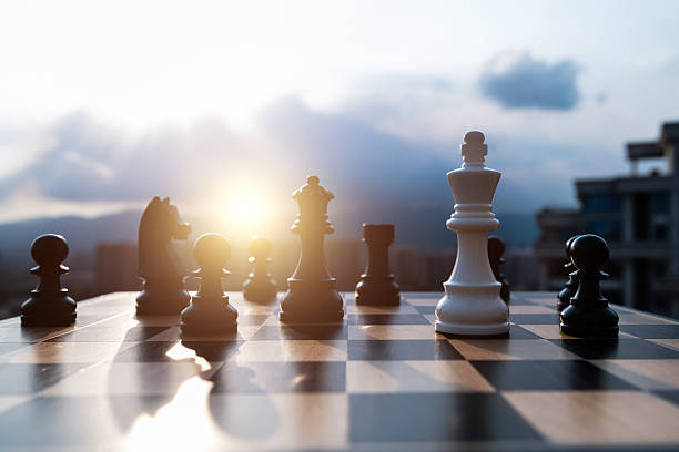 White chess king battle with black chess pieces