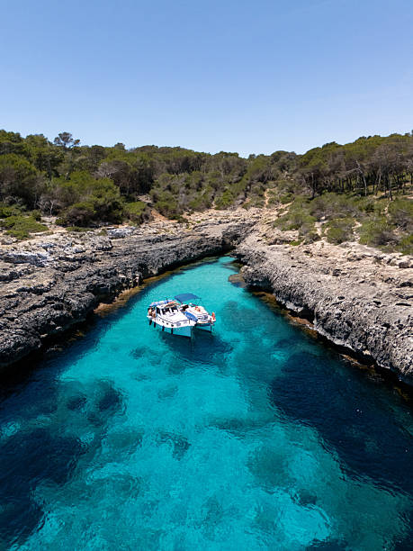 istock Boat anchored in narrow turquoise cove surrounded by cliffs 2218781680