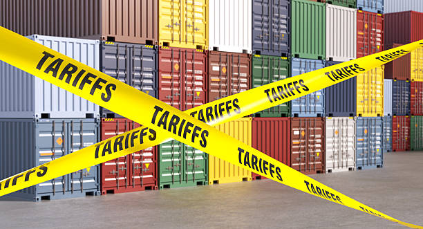 istock Tariffs barrier tape blocking international trade and shipping containers 2218782730
