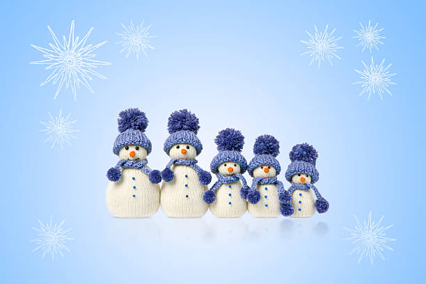 Christmas card of three snowmen in blue scarves and hats and white snowflakes on a blue background. Winter fairy tale story with your own hands, hobby. Merry Christmas and New Year 2026 greeting card
