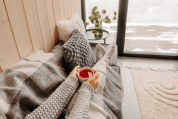 istock Hands Holding Cup of Tea Opposite Window 2218783987