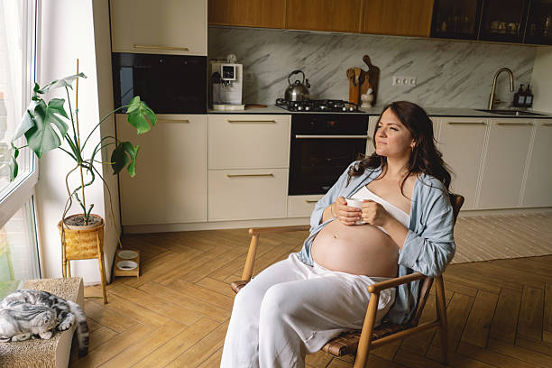 istock Expecting mother enjoys a warm drink 2218785327