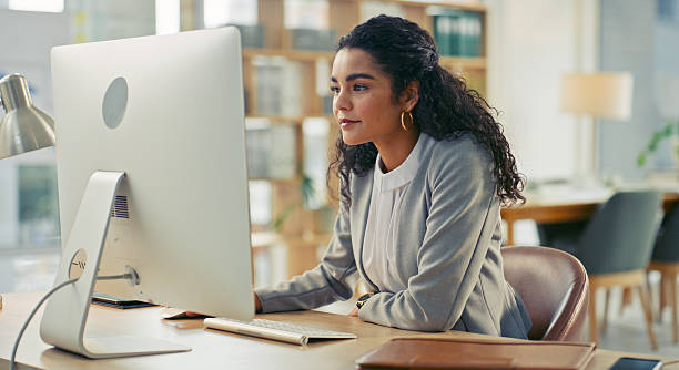Professional Woman Working at Computer in Modern Office Environment