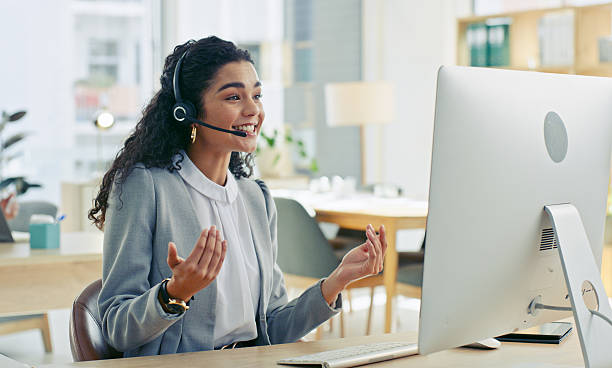 istock Smiling Professional Engaged in Video Call in Modern Office Workspace 2218785747