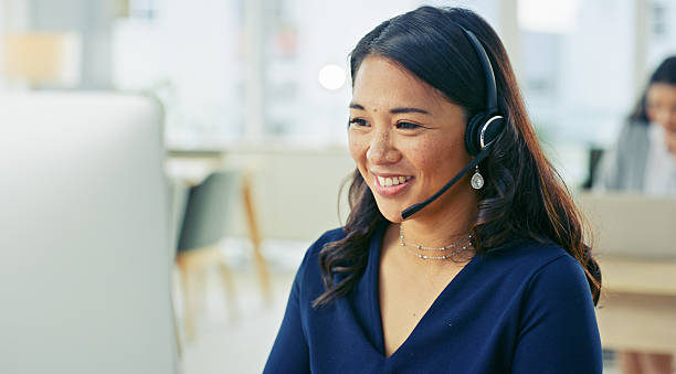 istock Smiling Businesswoman Using Headset in Modern Office Environment 2218785761
