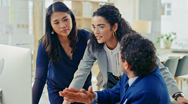 istock Focused Business Team Collaborating on Project in Modern Open Office Setting 2218785787