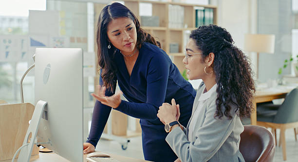istock Businesswomen Collaborating Together in a Modern Office Space 2218785804