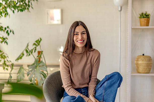 istock Young Woman Smiling and Relaxing at Home 2218788302