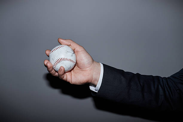 istock Caucasian Middle Aged Man in Suit Holding Baseball in Studio 2218789362