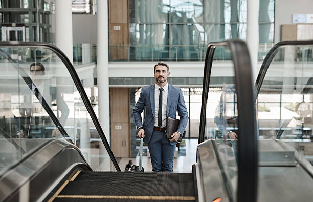 istock Professional Businessman on Escalator in Modern Building 2218789603