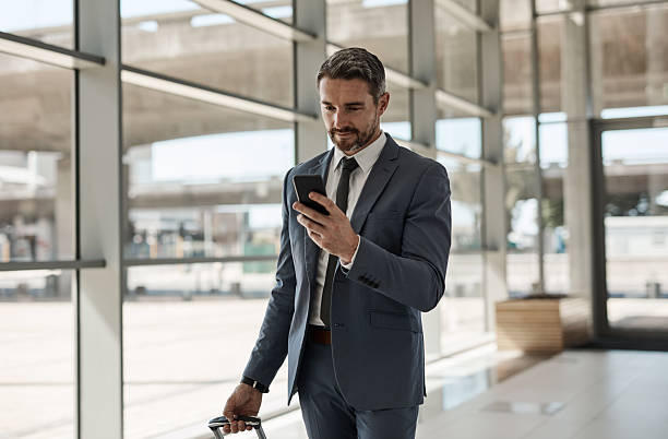 istock Businessman Traveling Through an Airport While Using His Smartphone 2218789613