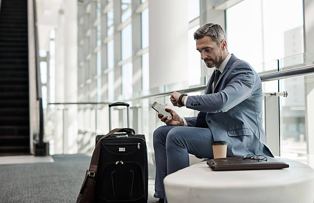 istock Professional Businessman Using Technology While Traveling in a Bright Modern Airport 2218789630